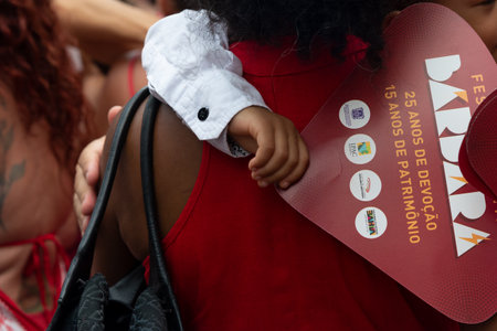 Salvador, Bahia, Brazil - December 04, 2023: Faithful embrace during a tribute to Santa Barbara in Pelourinho, city of Salvador, Bahia.のeditorial素材