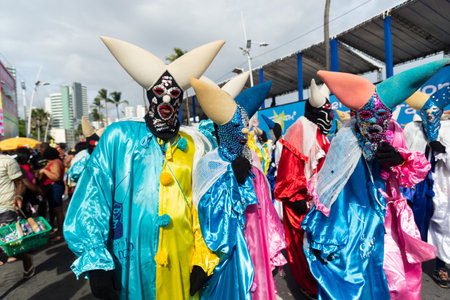 Salvador, Bahia, Brazil - February 11, 2023: Group of masked and costumed people parade in Fuzue, pre-carnival in Salvador, Bahia, Brazil.のeditorial素材