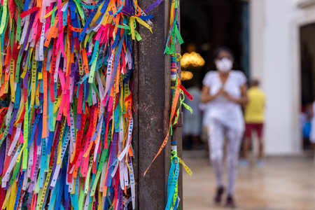 Salvador, Bahia, Brazil - August 12, 2022: Ribbons of souvenirs from Senhor do Bonfim tied to the railing of the Senhor do Bonfim church in the city of Salvador, Bahia.のeditorial素材
