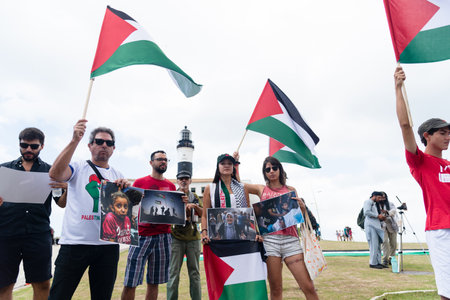 Salvador, Bahia, Brazil - November 11, 2023: Protesters are holding a Palestinian flag during a peaceful protest in the city of Salvador, Bahia.のeditorial素材