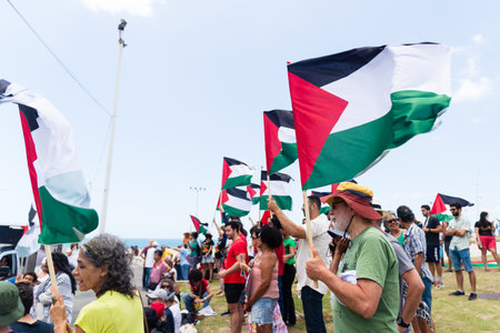 Salvador, Bahia, Brazil - November 11, 2023: Protesters are seen holding the Palestinian flag during a protest in the city of Salvador, Bahia.のeditorial素材