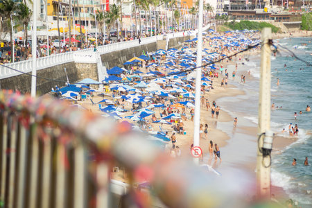 Salvador, Bahia, Brazil - January 05, 2022: People are seen on the Faro da Barra beach in the city...
