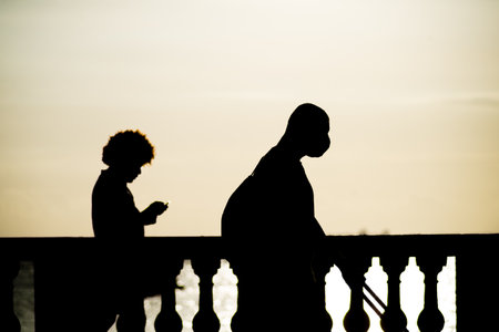 People are seen walking and having fun at sunset on the Porto da Barra waterfront in the city of Salvador, Bahia.の写真素材