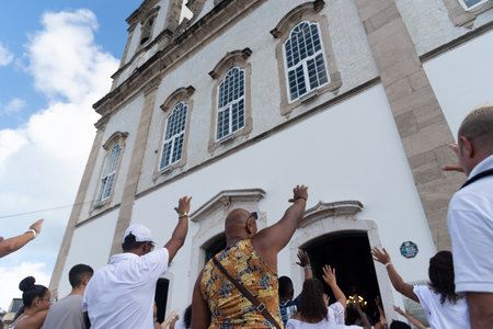 Salvador, Bahia, Brazil - December 29, 2023: Catholic faithful pray to Senhor do Bonfim during open mass in front of the church. City of Salvador, Bahia.のeditorial素材