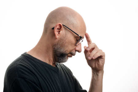 White man, bald, with prescription glasses, thoughtful and concentrated. Isolated on white...