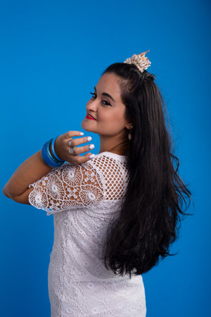 Beautiful young woman in white dress with shell tiara on her head looking to the side. Characterized...