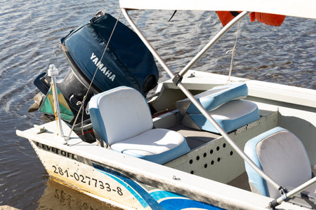 Aratuipe, Bahia, Brazil - May 30, 2015: A pleasure boat with a Yamaha engine stopped on the Jaguaripe river in Maragogipinho, a district of the city of Aratuipe in Bahia.のeditorial素材
