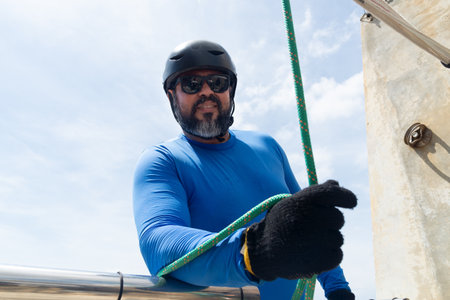 Rappeller carefully checking safety equipment for rappelling. Healthy sport.