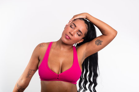 Beautiful woman dressed in gym clothes doing neck stretches. Healthy lifeの写真素材