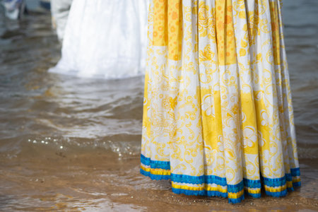 Lower part of unidentified people entering the water of the mara to pay homage to Iemanja. Salvador, Bahia.の写真素材