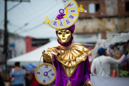 Maragogipe, Bahia, Brazil - February 11, 2024: People wearing Venetian carnival-style masks are seen during the carnival in the city of Maragogipe, in Bahia.のeditorial素材