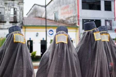 Maragogipe, Bahia, Brazil - February 11, 2024: Group of people in costumes and masks are seen having fun during the carnival in the city of Maragogipe, in Bahia.のeditorial素材