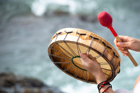 Salvador, Bahia, Brazil - February 02, 2024: People are seen playing percussion instruments during a party for Iemanja on Rio Vermelho beach in the city of Salvador, Bahia.のeditorial素材