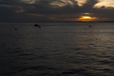 Dramatic sunset with dark clouds and sun in yellow color. City of Salvador, Bahia.の写真素材