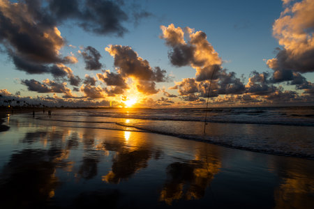 View of the day dawning with colorful clouds and the sun in yellow, orange and blue sky. Wonderful nature. Salvador, Brazil.の写真素材