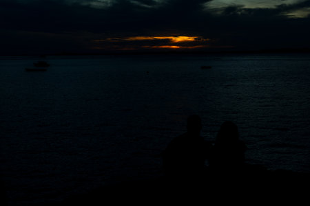 Dramatic sunset with dark clouds and sun in yellow color. City of Salvador, Bahia.の写真素材