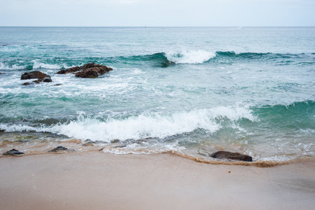 View of Farol da Barra beach with waves crashing on the rocks. Morning view.の写真素材