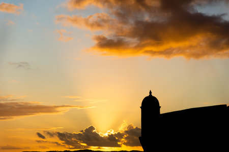 Silhouette of the tip of a nautical fort. Dramatic and orange sunset.の写真素材