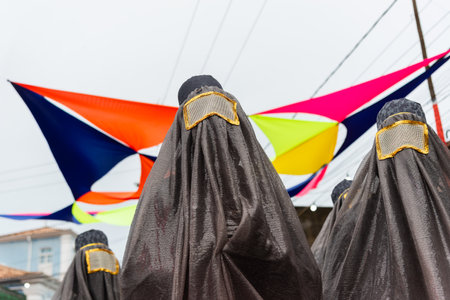 Maragogipe, Bahia, Brazil - February 11, 2024: People are seen wearing costumes and masks during the carnival in the city of Maragogipe in Bahia.のeditorial素材