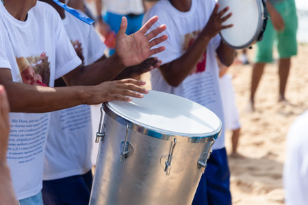 Salvador, Bahia, Brazil - February 02, 2024: People are seen playing percussion instruments during a...