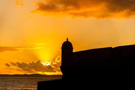 Silhouette of the tip of a nautical fort. Dramatic and orange sunset.の写真素材