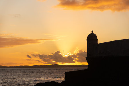 Silhouette of the tip of a nautical fort. Dramatic and orange sunset.の写真素材
