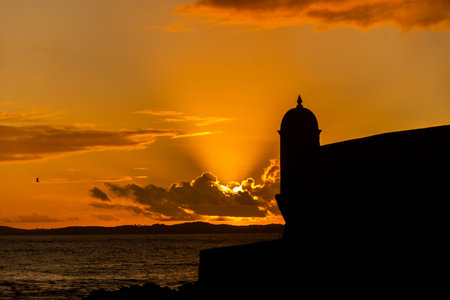 Silhouette of the tip of a nautical fort. Dramatic and orange sunset.の写真素材