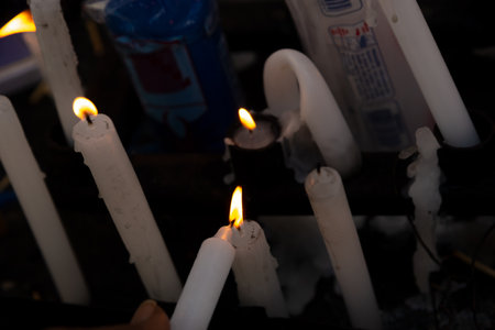 Several lit candles burning during the day.の写真素材