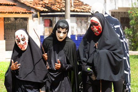 Santo Amaro, Bahia, Brazil - July 27, 2015: People are seen wearing horror costumes and masks in the Acupe neighborhood, in the city of Santo Amaro, Bahia.のeditorial素材