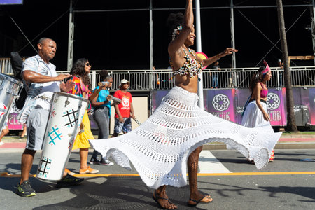 Salvador, Bahia, Brazil - February 03, 2024: People dressed in traditional cultural clothing are seen dancing during the Fuzue pre-carnival parade in the city of Salvador, Bahia.のeditorial素材