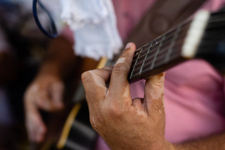 Detail of hands playing a guitar with nylon strings. Professional musician.