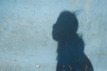 Shadow cast on a wall by an unidentified person. Textureの写真素材