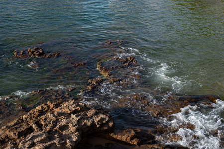 Dark sea rocks. Strong sunny day. Preserved nature.の写真素材