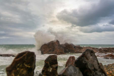 Sea waves crashing hard against a rock in winter. winter storm.の写真素材