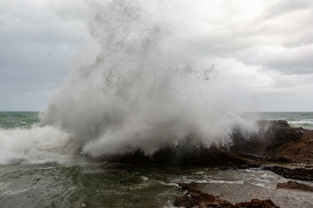 Sea waves crashing hard against a rock in winter. winter storm.の写真素材