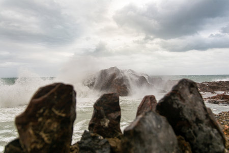 Waves hitting a sea rock with great force. winter storm.の写真素材