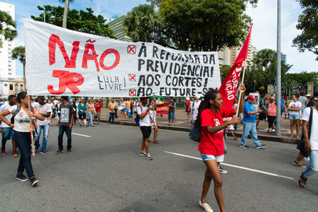 Salvador, Bahia, Brazil - August 13, 2019: Students are seen with flags during a protest against cuts to education by President Jair Bolsonaro in the city of Salvador, Bahia.のeditorial素材