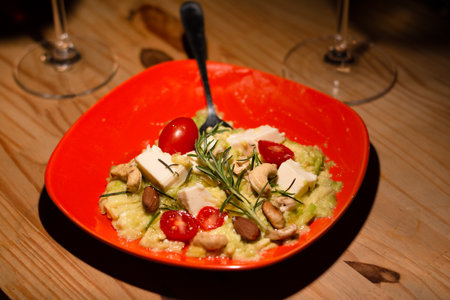 A red plate with salads inside on a wooden table. Wine accompaniment. food photographyの写真素材