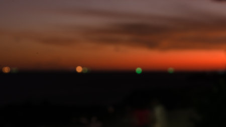 Dramatic sunset with bokeh effect with colorful clouds and silhouette. Beautiful nature.の写真素材
