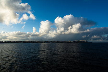 Ocean landscape with big white clouds in the sky. South America. In the distance the city of Salvador, Brazil.の写真素材