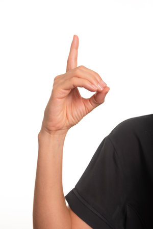 Close-up of a female arm and hand making the letter D in the Brazilian sign language for the deaf, Libras. Salvador, Bahia.の写真素材