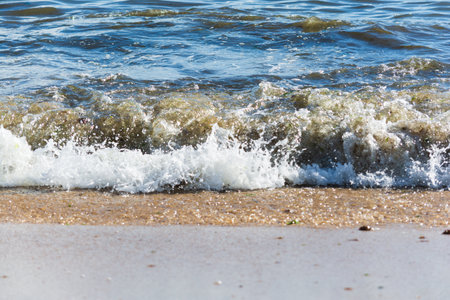 Small waves crashing on the shore. Splendid nature.の写真素材