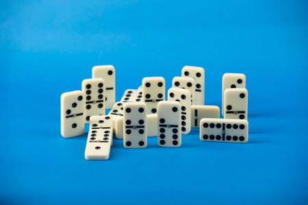 Dominoes with blue background, copy space and various angles. White Bones Board Game.の写真素材