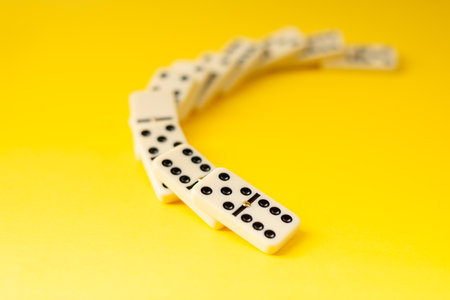 Dominoes on a yellow background. White Bones Board Game.の写真素材