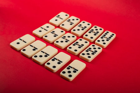 Dominoes on a red background. White Bones Board Game.の写真素材
