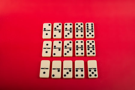 Dominoes on a red background. White Bones Board Game.の写真素材