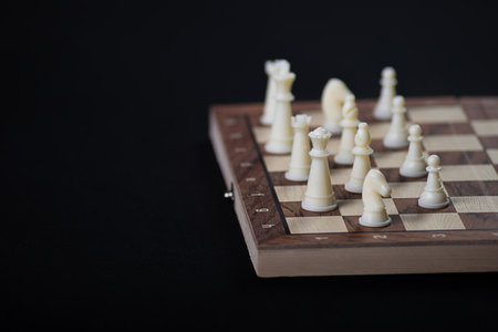 Chess board with light and dark pieces. Game concepts. Board game. Hobby. Chess on the playing field for a game on a black background.の写真素材