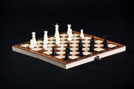 Chess board with light and dark pieces. Game concepts. Board game. Hobby. Chess on the playing field for a game on a black background.の写真素材