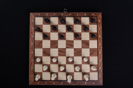 Chess board with pieces. Game concepts. Board game. Hobby. Photographed from above. Game on black background.の写真素材
