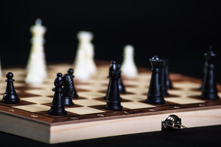 Chess board with light and dark pieces. Game concepts. Board game. Hobby. Chess on the playing field for a game on a black background.の写真素材